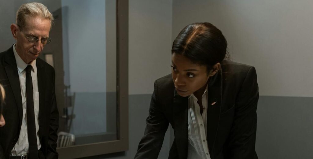 A scene showing a prison interrogation with a detective and inmate at a table.